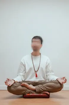 Adult man practicing meditation in a serene indoor setting, focused on