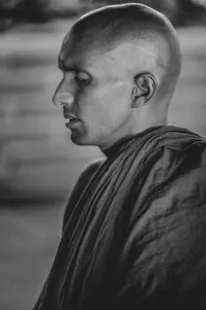 Black and white portrait of a meditative monk in traditional robe capturing