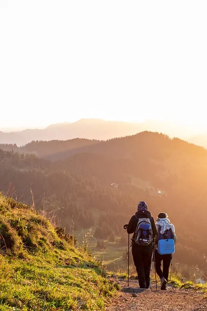 Person hiking toward a mountain sunrise embodying the abundance mindset