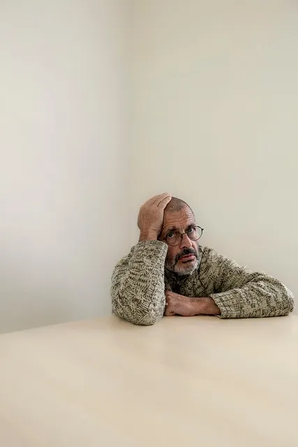 Man sitting with the honest weight of years of unsustainable professional output