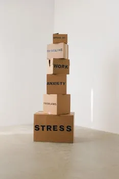 Vertical stack of cardboard boxes labeled with stress-related words,