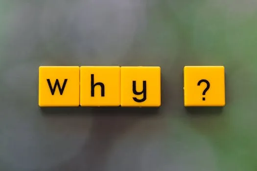Yellow letter tiles spelling why? create a thought-provoking scene on a