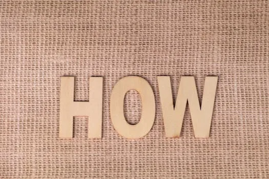 Word HOW formed with wooden letters on textured burlap surface.