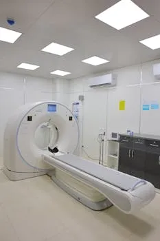 High-tech CT scanner in a bright, well-equipped hospital room for medical