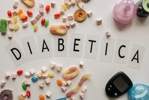 Close-up of candies and diabetes-related items on a white surface, featuring