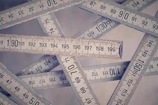 A collection of vintage folding rulers measuring in centimeters on a neutral