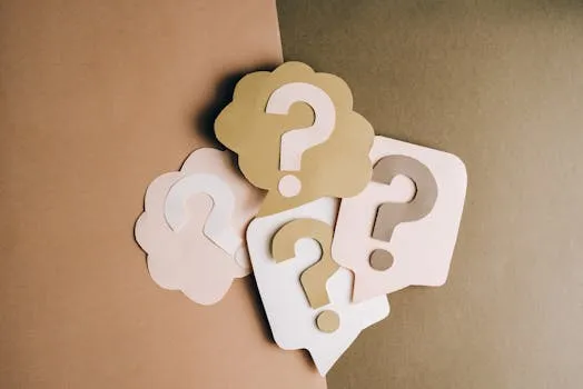 Question mark cutouts in layered paper craft style on a brown backdrop,