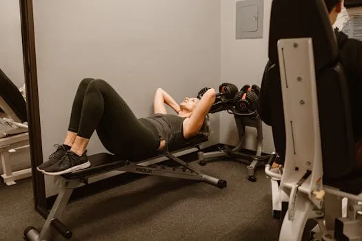Adult woman exercising on a bench in a gym, promoting fitness and healthy